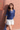 Female wearing a Blue Solid Color Fusion V-Neck Neckline No Collar Top