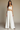 Female wearing a White Solid Color   Western Style V-Neck Neckline Cotton Slub Top