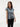 Female wearing a White  Color Blue Geometric Print Fusion Style V-Neck Neckline Cotton Cambric Top