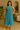 Female wearing a Ferozi Blue Solid Color Slip Scoop Neckline No Collar  Dress