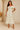 Female wearing a Off-White Sanganeri, Purple Daisies & Leaf Butta Print Bodycan Dress