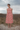 Female wearing a Off White  Color Off White 4 Petal Flowers Print A-Line Style V-Neck Neckline Cotton Shifli Dress