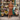 Female wearing a Rust  Color Floral Butta Print House Style Boat Neckline Polyester Muslin Dress