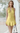 Female wearing a Yellow Solid Color Babydoll V-Neck Neckline Dress