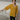 Female wearing a Mustard Solid Color Fusion Wrapped Neckline No Collar Top