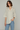 Female wearing a White Solid Color   Fusion Style V-Neck Neckline Cotton Slub Tunic