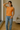 Female wearing a Orange Solid Color Western Round Neckline Top