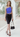Female wearing a Ferozi Blue Solid Color Western Asymmetric Neckline Top