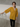 Female wearing a Yellow Solid Color Fusion V-Neck Neckline No Collar Tunic