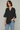 Female wearing a Black Solid Color   Fusion Style V-Neck Neckline Cotton Slub Tunic
