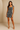 Female wearing a Black And White Leaf Asymmetrical  Print Babydoll Dress