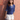 Female wearing a Blue Solid Color Fusion V-Neck Neckline No Collar Top