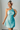 Female wearing a Ferozi Blue Solid Color Bodycan Asymmetric Neckline Dress