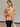Female wearing a Peach  Color Floral Jaal Butta Print Fusion Style V-Neck Neckline Cotton Cambric Tunic