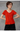 Female wearing a Orange Solid Color Fusion V-Neck Neckline No Collar Top