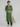 Female wearing a Greenish Rust Solid Color Kurta V-Neckline Neckline Mandarin Collar Shirt